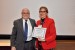 Dr. Nagib Callaos, General Chair, giving Prof. Zainab Z. Ismail the best paper award certificate of the session "Information Systems, Technologies and Applications II." The title of the awarded paper is "A Novel Application of Polyvinyl Chloride (PVC) Waste Material as a to Replace Membrane in Microbial Fuel Cell Treating Actual Potato Chips Processing Wastewater."